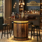 Round rustic barrel table with stools in bright home bar with brick wall